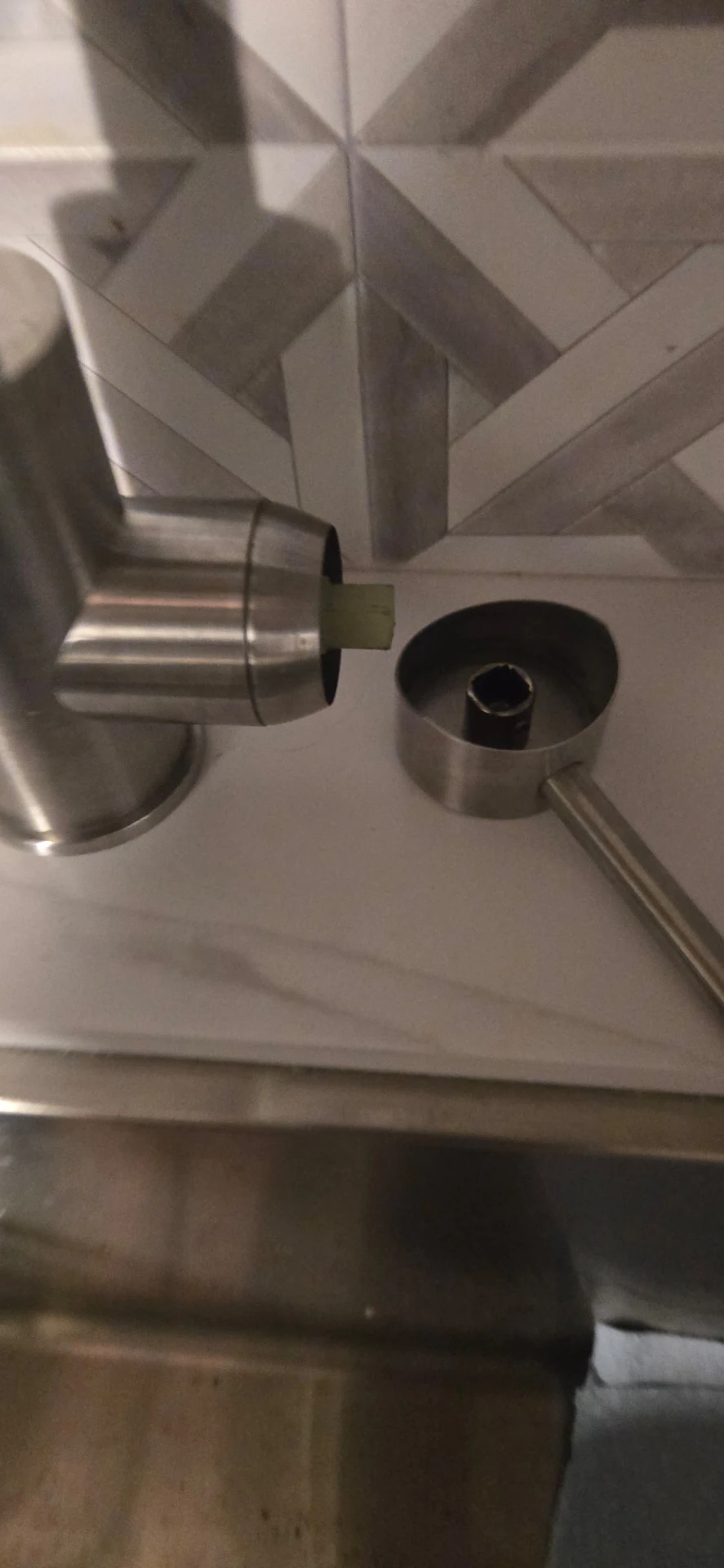 Disassembled faucet handle beside an RV sink